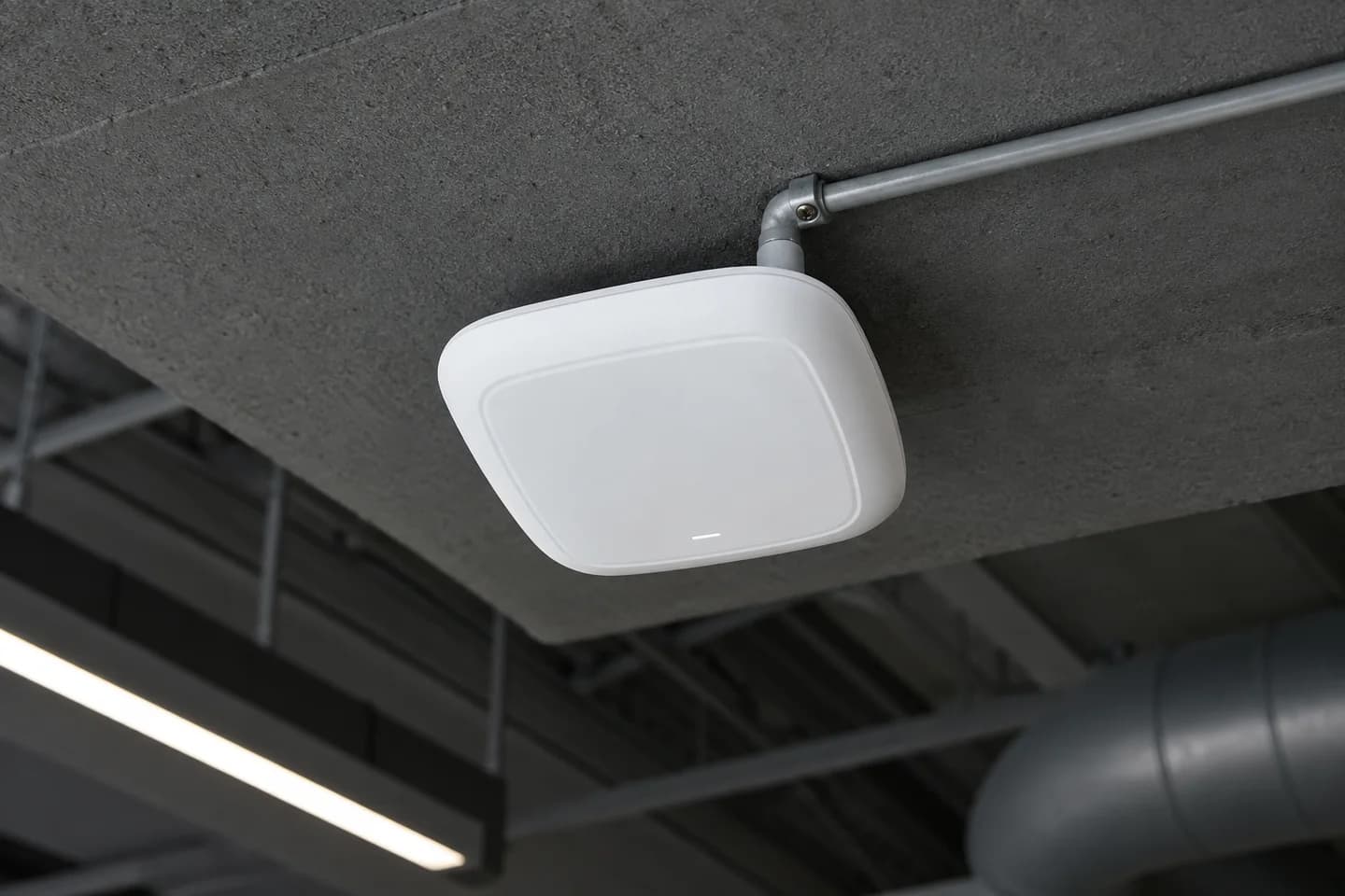 Illustration of a wireless access point mounted on a commercial ceiling.